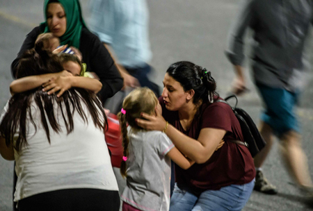Children and their relatives embrace as they leave Ataturk airport on June 28, 2016 in Istanbul after two explosions followed by gunfire hit Turkey's biggest airport, killing at least 28 people and injuring 20. (AFP)