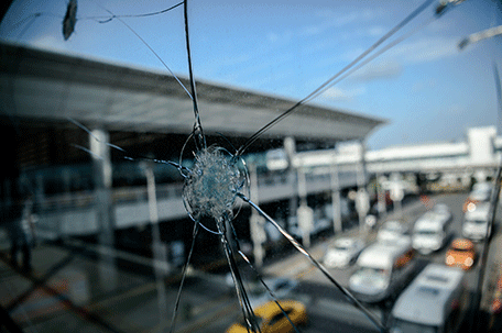 Bullet impacts are pictured on a window at Ataturk airport's International airport on June 29, 2016, a day after a suicide bombing and gun attack targeted Istanbul's airport, killing at least 36 people. A triple suicide bombing and gun attack that occurred on June 28, 2016 at Istanbul's Ataturk airport has killed at least 36 people, including foreigners, with Turkey's prime minister saying early signs pointed to an assault by the Islamic State group. AFP