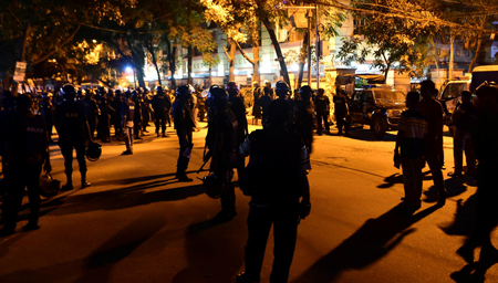 Bangladeshi security personnel stand guard outside a restaurant during an attack in Dhaka's high-security diplomatic district early on July 2, 2016.(AFP)