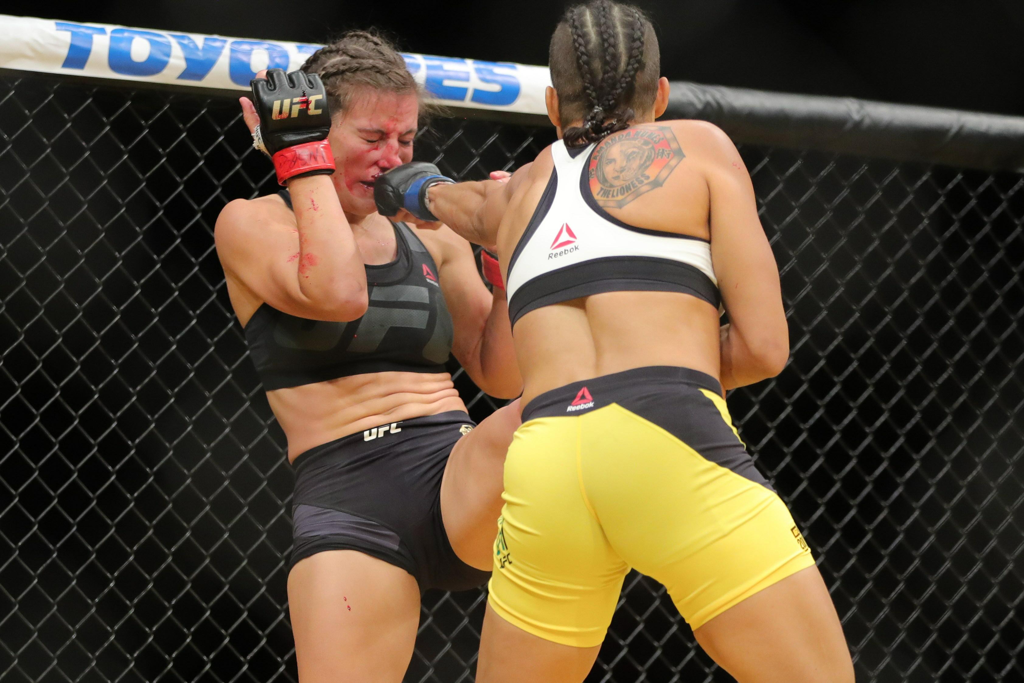 Amanda Nunes punches Miesha Tate (left) during the UFC 200 event at T-Mobil...