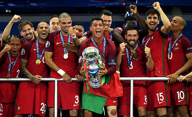Cristiano Ronaldo (centre) of Portugal lifts the European Championship trophy after his side win 1-0 against France during the UEFA EURO 2016 Final match between Portugal and France at Stade de France on July 10, 2016 in Paris, France. (Getty Images)
