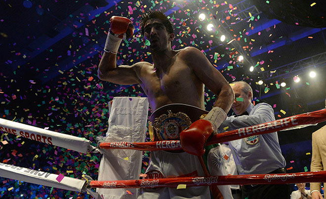 India's boxer Vijender Singh celebrates after defeating Australia's boxer Kerry Hope for the WBO Asia Pacific Super Middleweight title in New Delhi on July 16, 2016. (AFP)