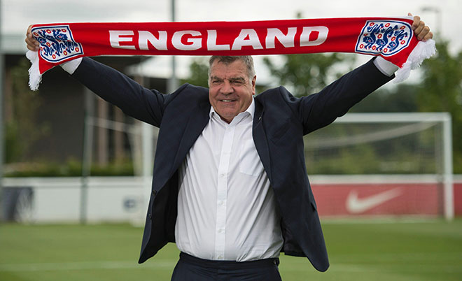 New England football team manager Sam Allardyce holds up an England scarf during a photocall at St George's Park, near Burton-on-Trent, central England, on July 25, 2016.  (AFP)