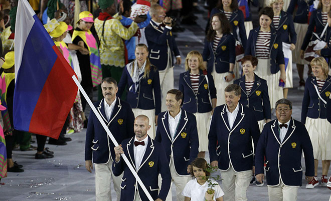 Flagbearer Sergey Tetyukhin (RUS) of Russia leads his contingent during the opening ceremony. (Reuters)