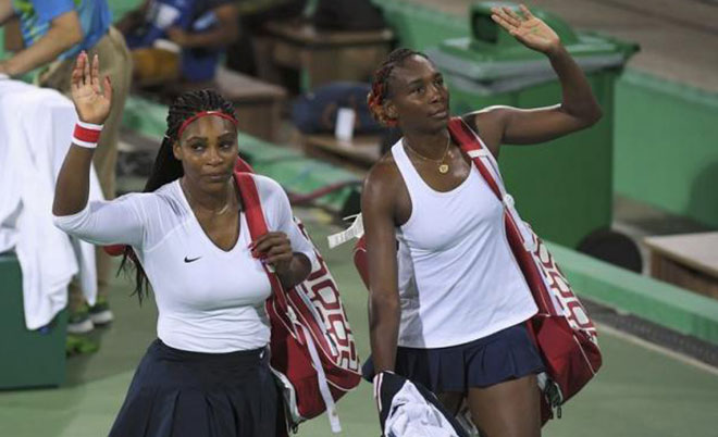 Serena Williams and Venus Williams of USA leave after losing their match against Lucie Safarova (CZE) of Czech Republic. (Reuters)