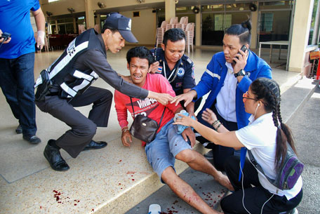A man is treated for injuries at the scene of a bomb explosion in the upscale resort town of Hua Hin. (AFP)