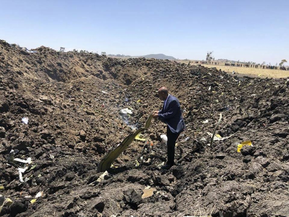 In this photo taken from the Ethiopian Airlines Facebook page, the CEO of Ethiopian Airlines, Tewolde Gebremariam, looks at the wreckage of the plane that crashed shortly after takeoff from Addis Ababa, Ethiopia, Sunday March 10, 2019. (AP)