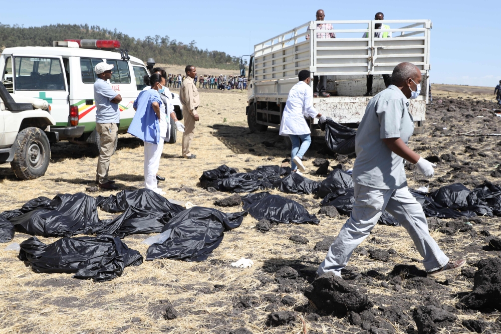 Rescue team walk past collected bodies in bags at the crash site of Ethiopia Airlines near Bishoftu, a town some 60 kilometres southeast of Addis Ababa, Ethiopia. (AFP)