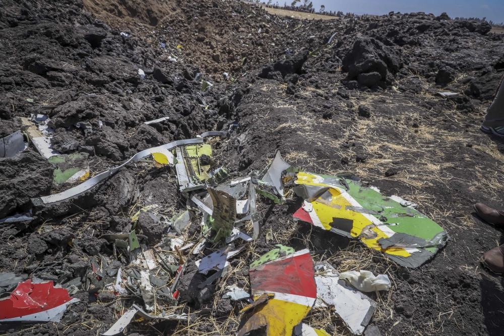 Wreckage lies at the scene of an Ethiopian Airlines flight that crashed shortly after takeoff at Hejere near Bishoftu, or Debre Zeit, some 50 kilometers (31 miles) south of Addis Ababa, in Ethiopia. (AFP)