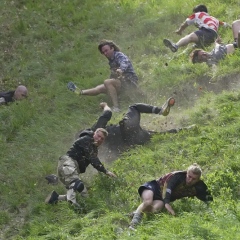 Photo: Rolling thunder: Contestants chase cheese wheel down a hill in chaotic UK race